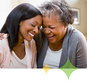 Alzheimer's patient and adult daughter laugh together, planning for the future